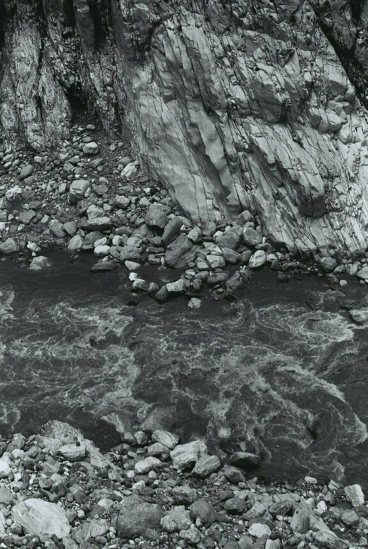 A black and white photo of water rushing through Taroko Gorge in Taiwan