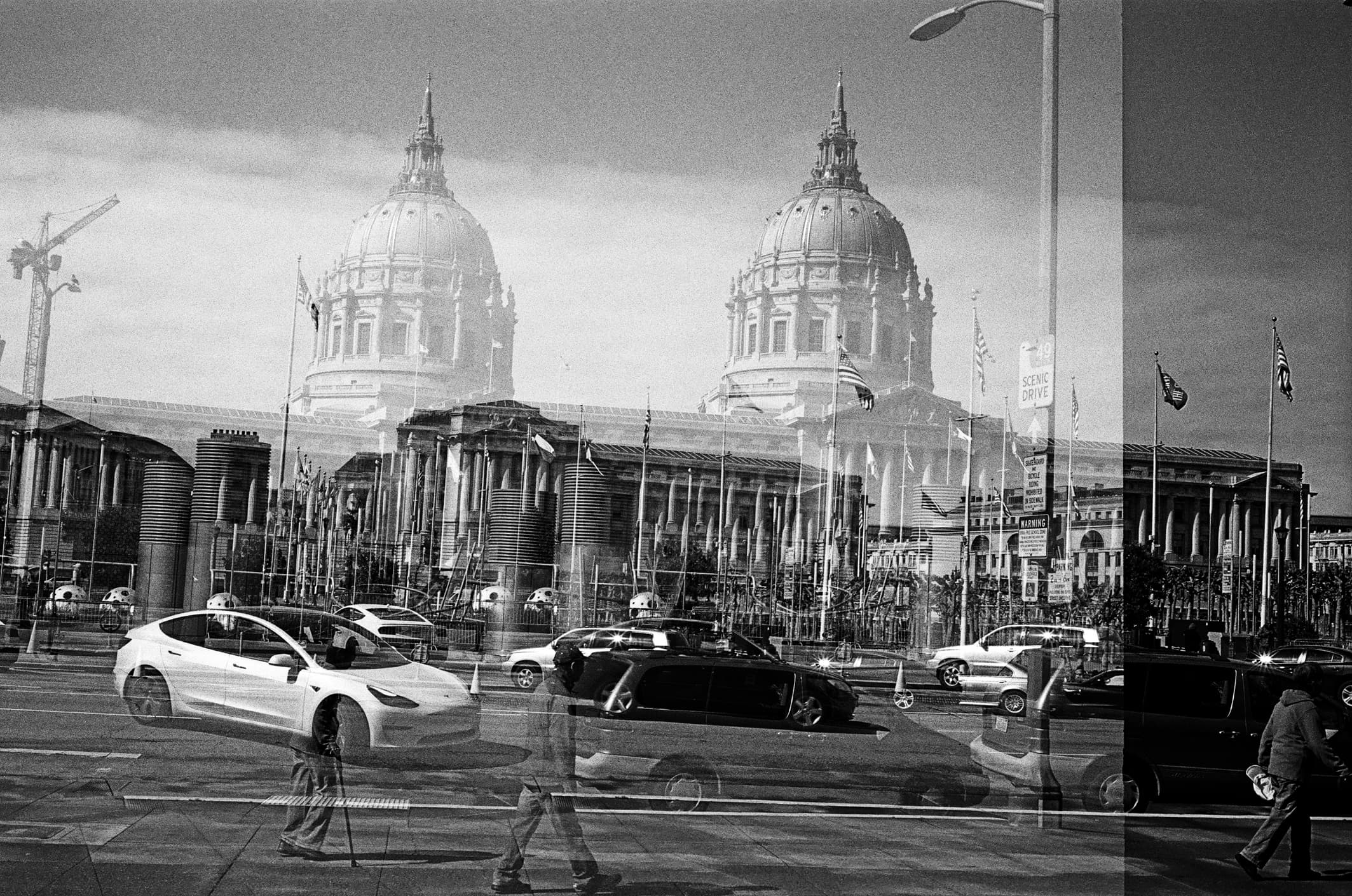 a scan of a black and white film negative of san francisco city hall with a double exposure