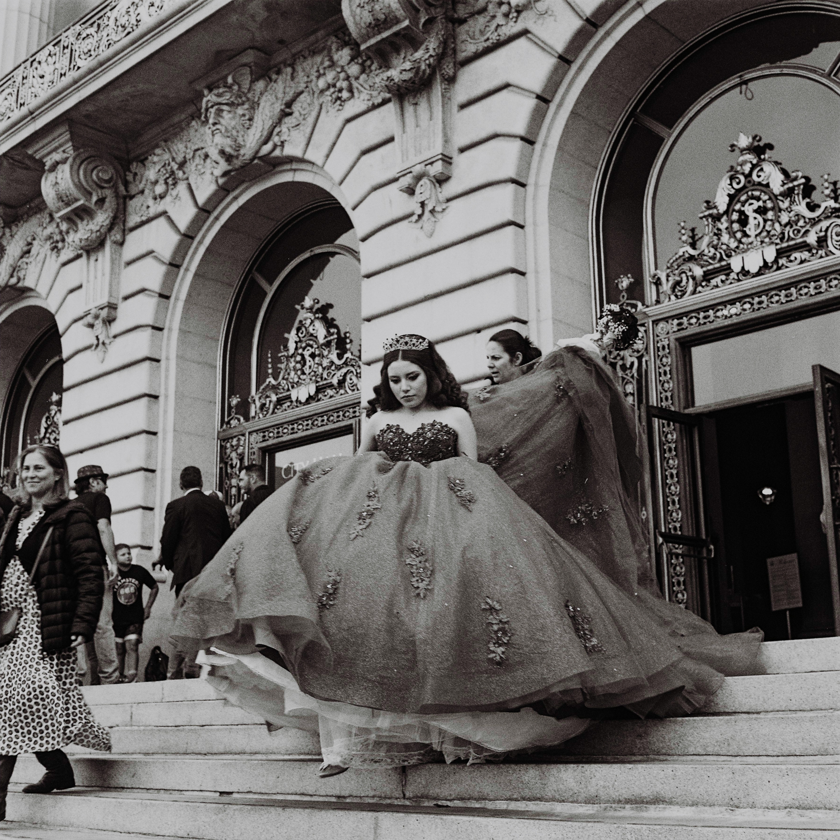 a scan of a black and white photo of a bride coming out of San Francisco City Hall