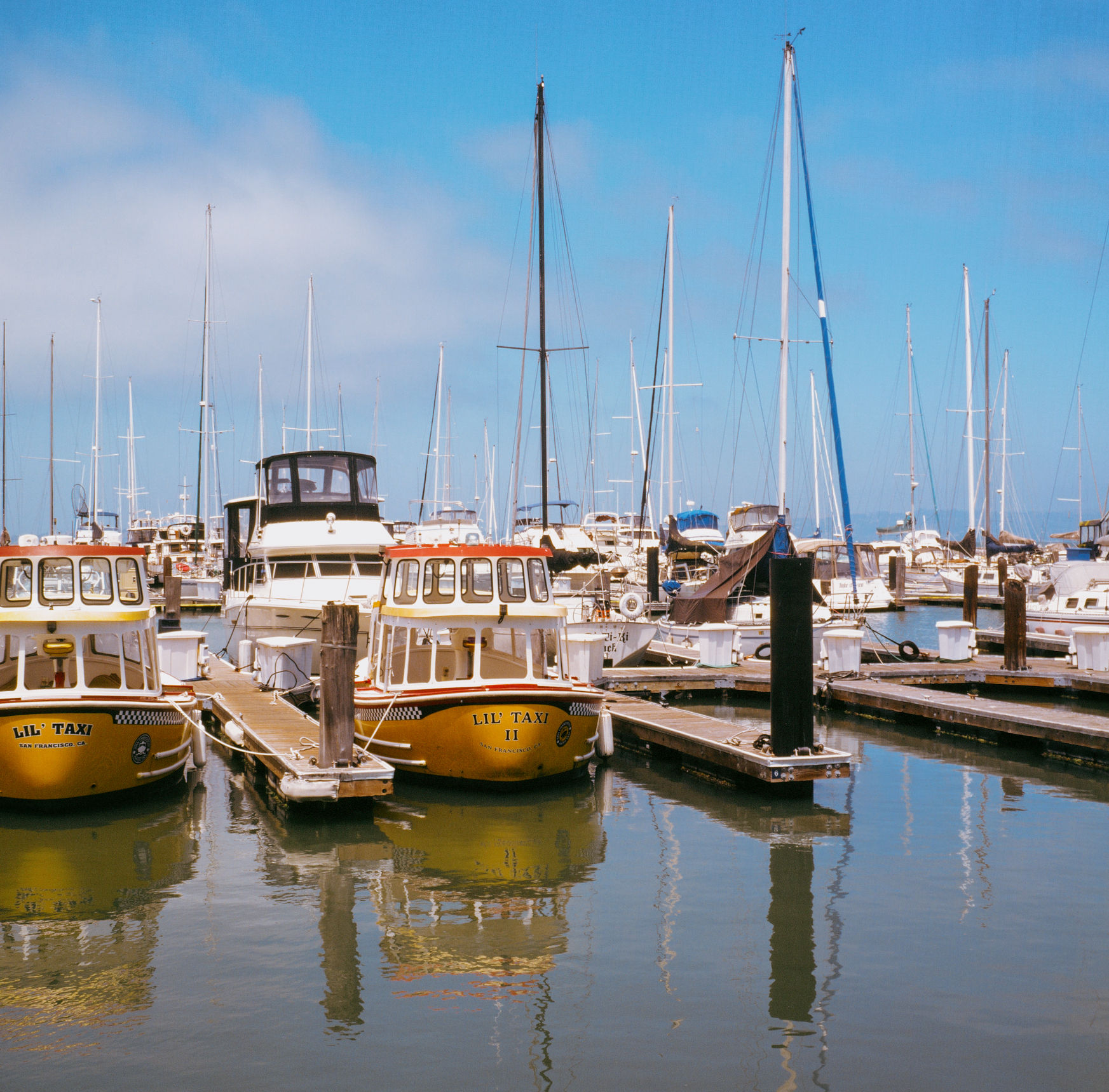 a scan of a color slide photo of some boats at fishermans wharf in san francisco