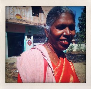 Woman in a sari riding in the autorickshaw