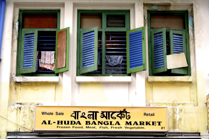 Wide urban skyline at dusk with dense buildings and city lights.