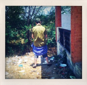 Andrew standing by roadside bushes during the rally