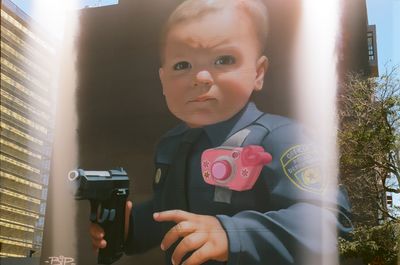 Mural in Hayes Valley, San Francisco, featuring a giant baby holding a weapon