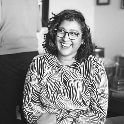 a photo of a beautiful woman wearing a very distinctive top. the photo is black and white and shot on film
