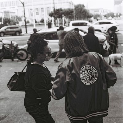 a scan of a black and white photo showing people at the SAG-AFTRA support rally holding protest signs outside San Francisco City Hall