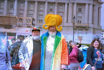 a scan of a color photo showing showing a person wearing an amazing costume with a very dramatic hair set