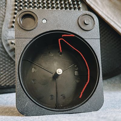 a photo of the back of a film loader, with a red arrow showing the direction in which to unwind and load the film