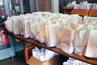 a scan of a color photograph showing many gift bags on a table