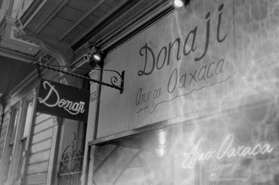 a scan of a black and white photo showing a Mexican restaurant called Donaji and its front door. There are a bunch of bubble patterns on the right side of the image