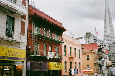 a color photograph of Chinatown San Francisco with TransAmerica building in the background. Also with dark skies