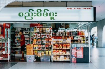 1. A scan of a color photo of a Burmese grocer in Singapore
