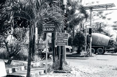 a scan of a black and white photo of street signs in surabaya