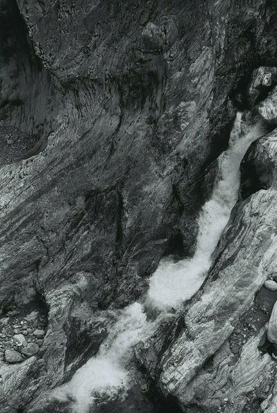 A black and white photo of rocks and sand in Taroko Gorge in Taiwan