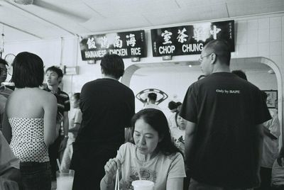 a black and white photo of a food scene inside a famous Malacca restaurant known for their chicken rice balls
