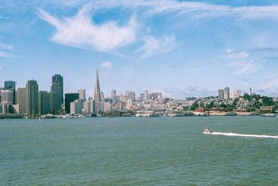 a scan of a color photo of the San Francisco skyline with a boat in the bottom right of the photo