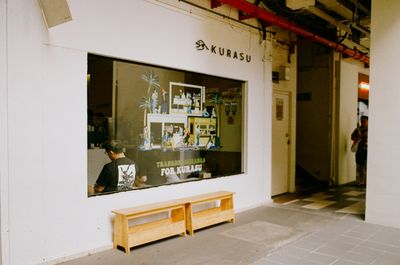 a scan of a color photo showing the exterior of a Japanese-inspired coffee shop in Singapore called Kurasu