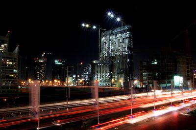 a digital photograph of a time lapse scene of Sheikh Zayed Road in Dubai with lots of construction and lights
