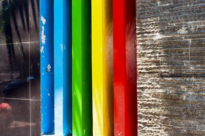 a scan of a color photo showing rainbow colored pillars outside a kindergarten in Indonesia