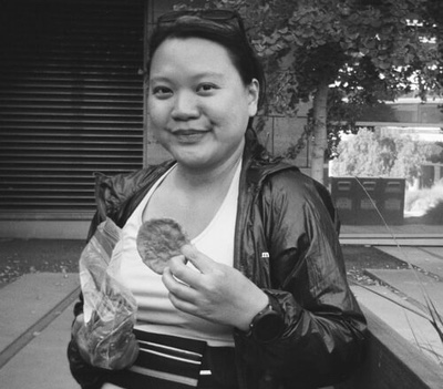 a photo of the author of the page in black and white, holding a snack, and smiling